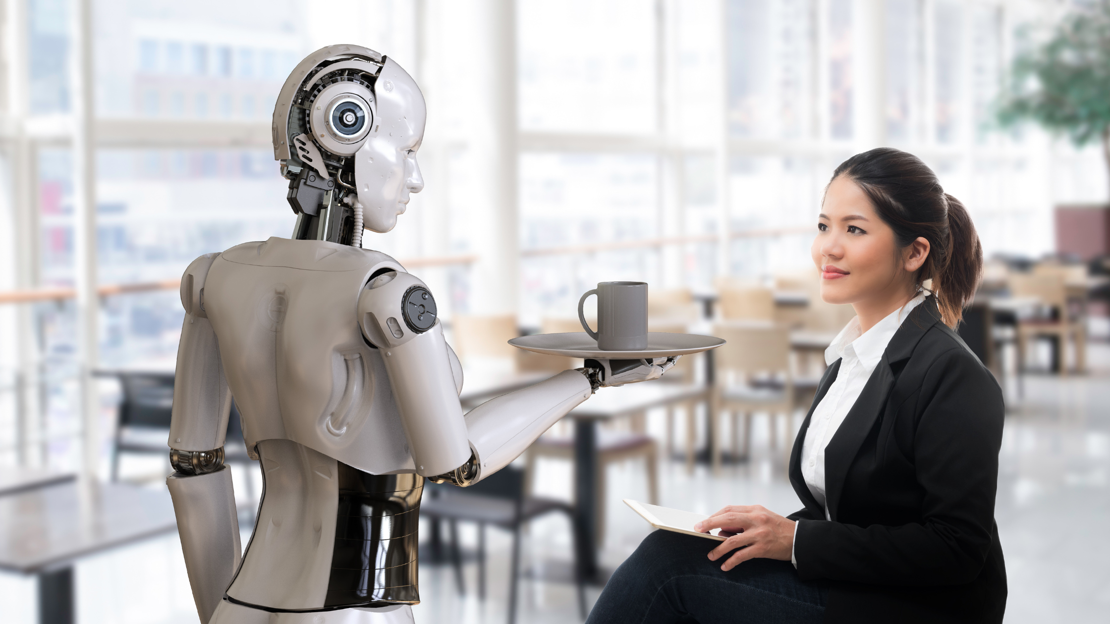 A robot serving a human at a cup of coffee